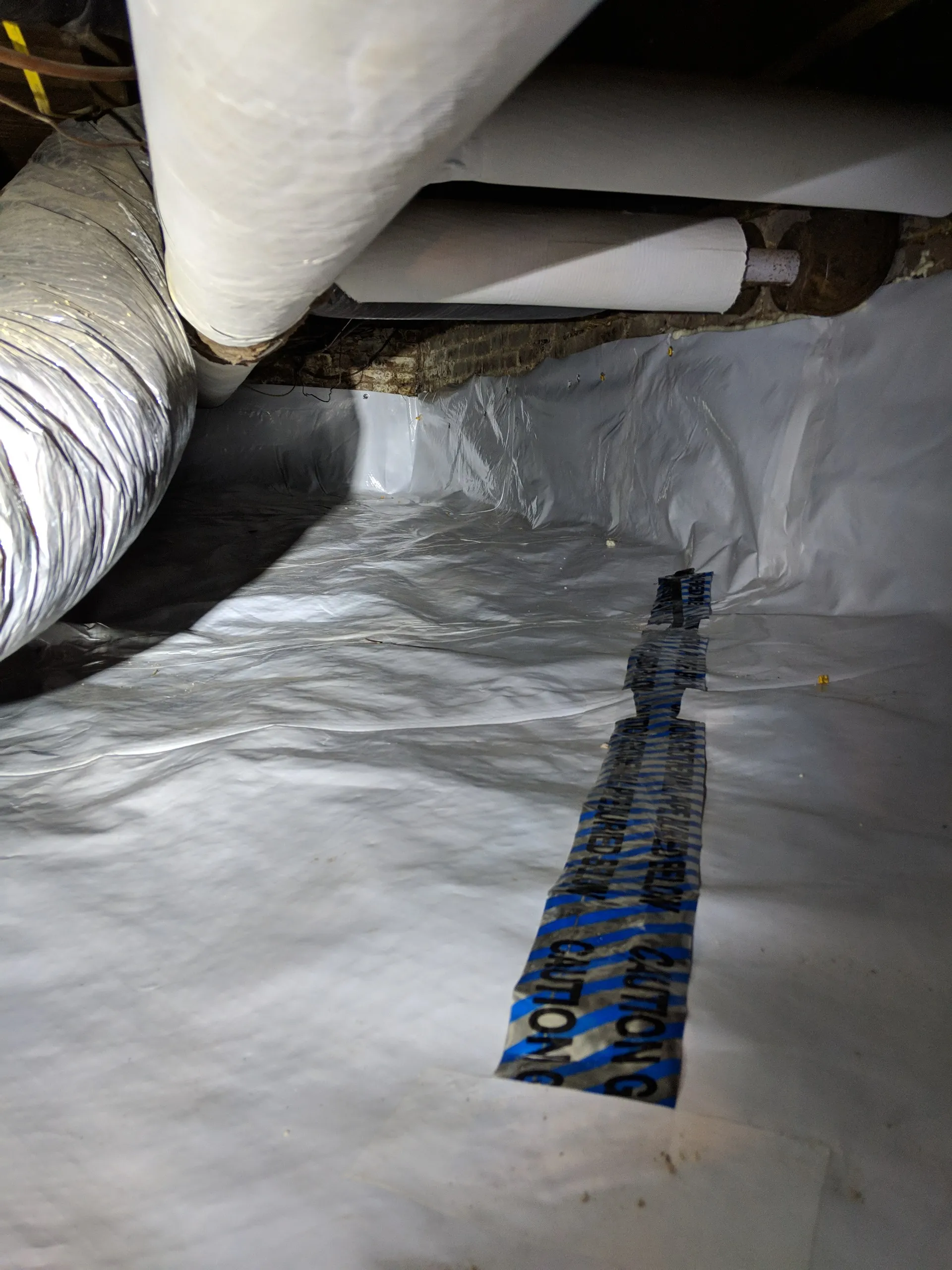 Encapsulating plastic installed (with geothermal locating tape!)
