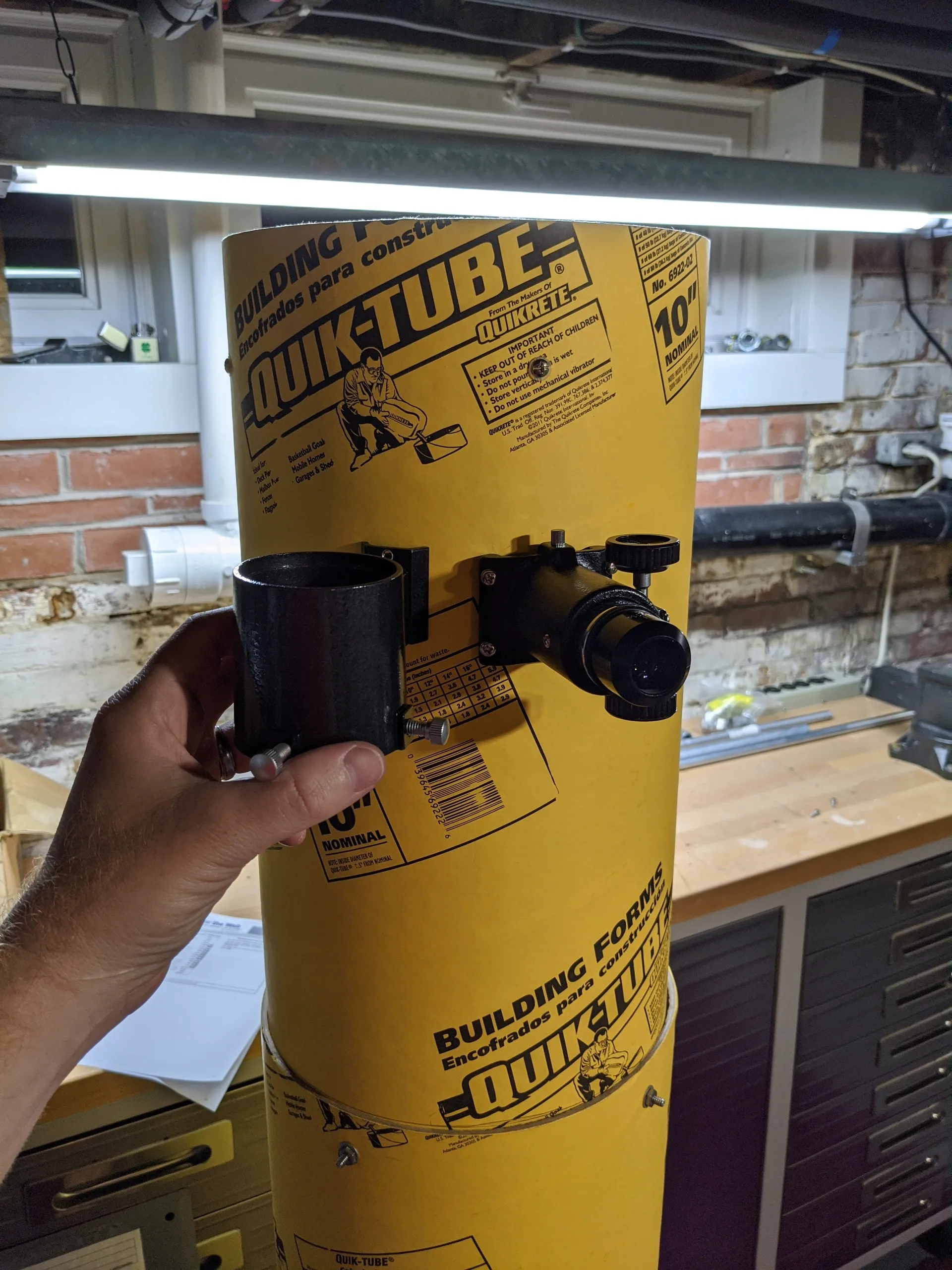 The finder scope and focuser mounted to the side of the yellow Quik-Tube, near the tube’s open end