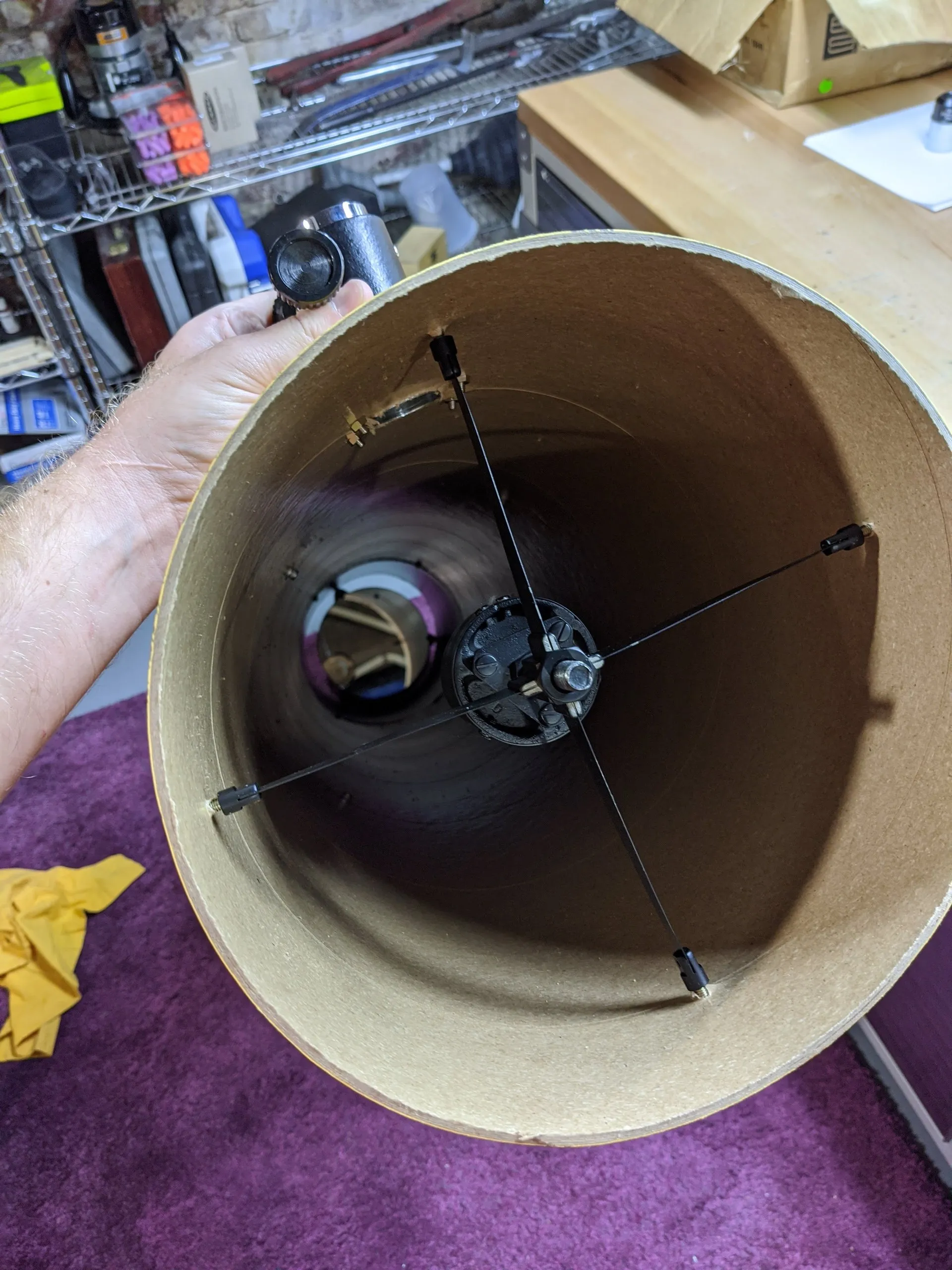 Looking down the tube at the primary mirror cell, with the secondary mirror and its spider vanes visible in the foreground