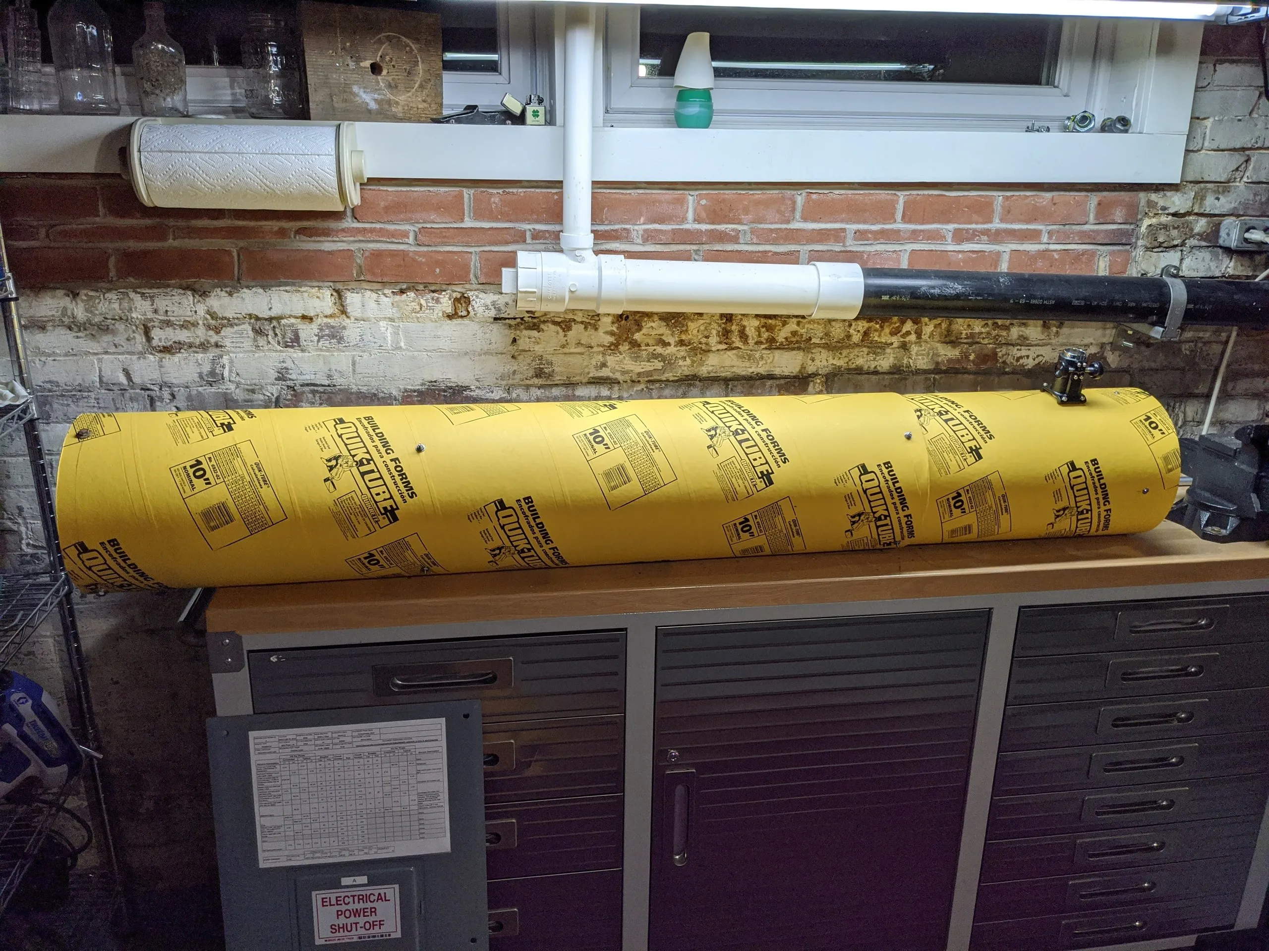 A 10-inch Quik-Tube concrete form tube on a workbench, cut to length for the telescope’s optical tube