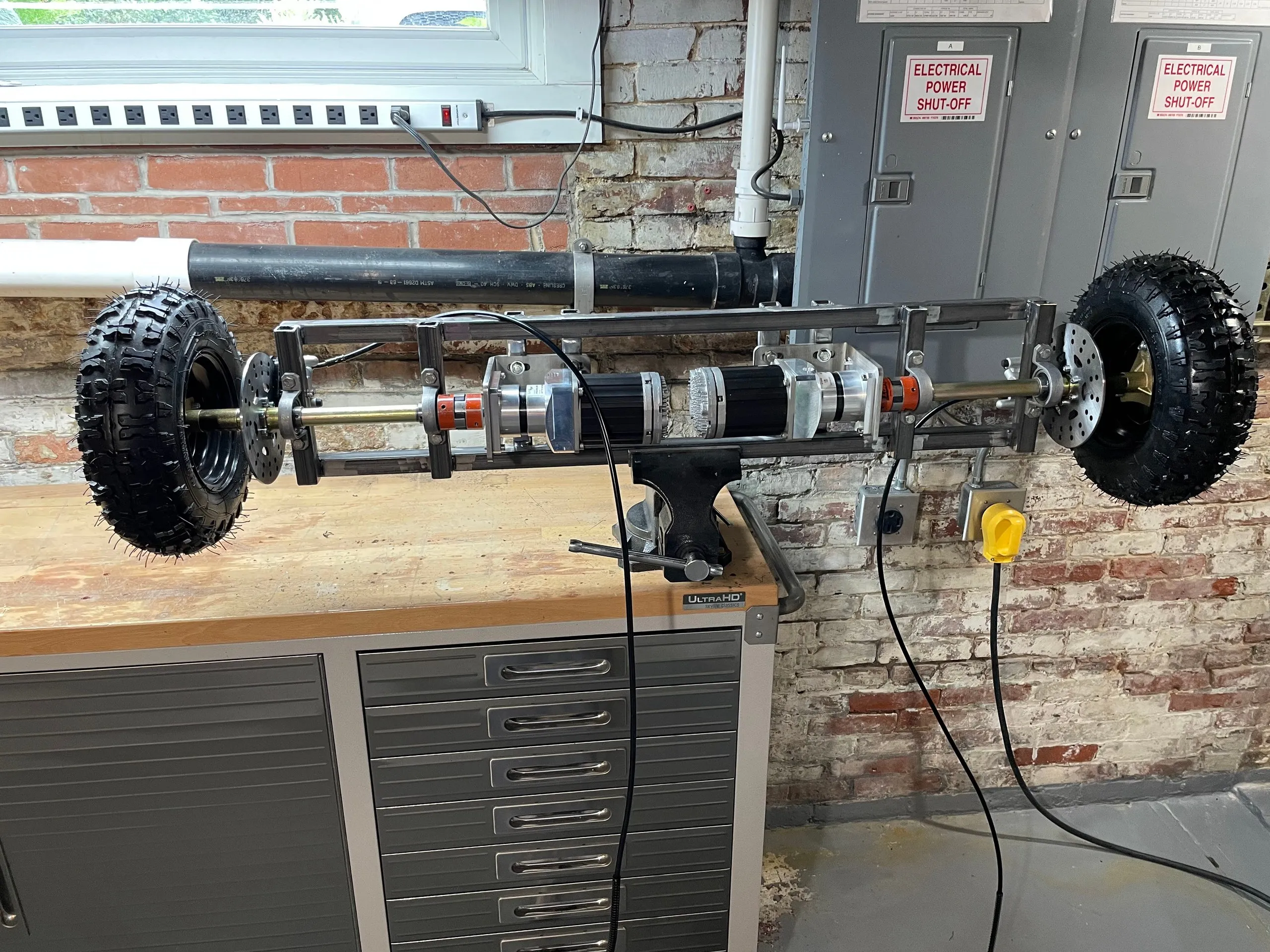 The subframe with both wheels fitted, clamped in a bench vise