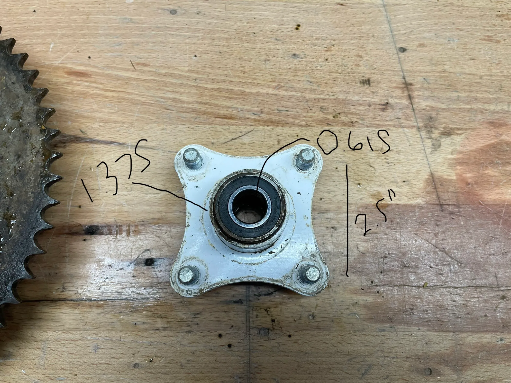 The same hub with measurements written on the photo: 0.615 inch bore, 1.375 inch bolt circle and 2.5 inches across